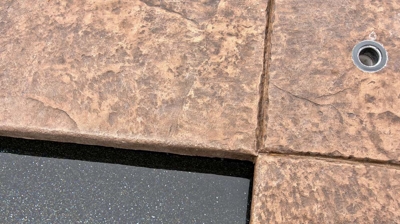 Up close view of stone work surrounding a pool Photo